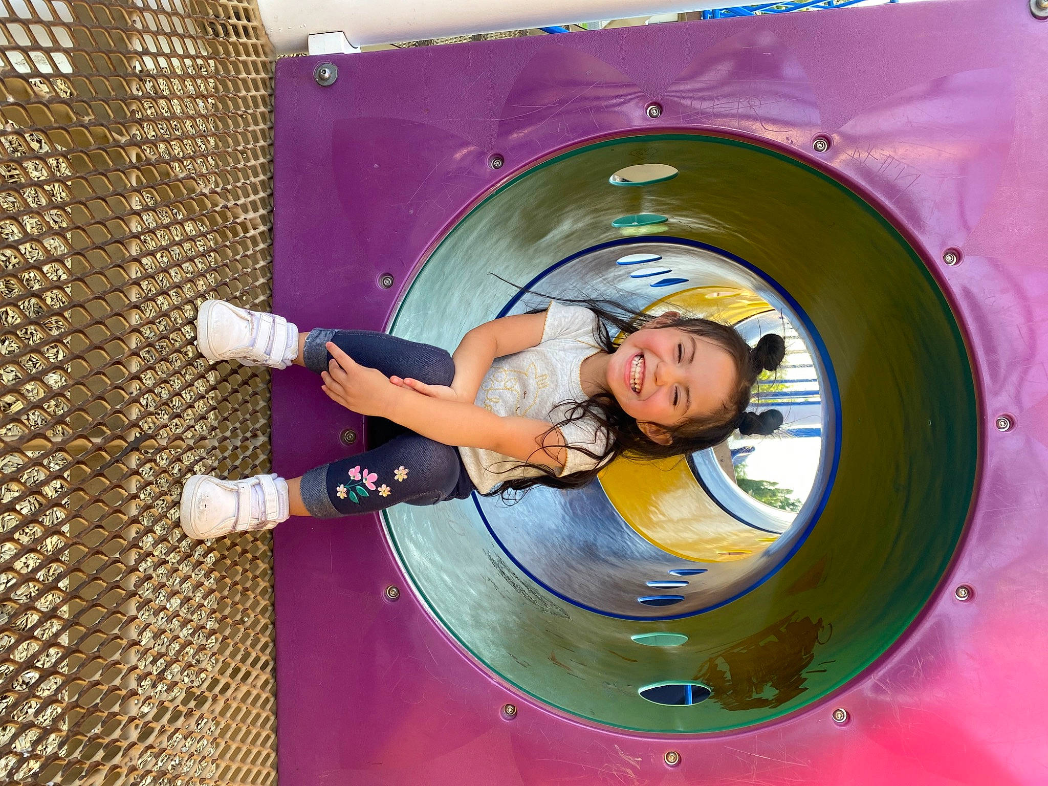 Yaliah is registered to the contest to win money with this photo: auto_part, automotive_tire, automotive_wheel_system, child, circle, facial_expression, fun, happy, hat, helmet, joy, leisure, machine, magenta, person, pink, play, playground, purple, recreation