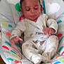 Aubrey joined the competition — help win amazing prizes! baby, child, pajamas, infant, cushion, baby_seat, indoor, childcare, comfort, colorful, patterned_clothing, soft_focus, face, person, sitting, young_child, furniture, relaxation, home, cute