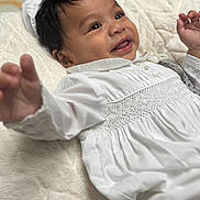 Sebastian joined the competition — help win amazing prizes! baby, infant, smiling, white_clothing, blanket, cute, portrait, child, happy, indoors, soft_texture, reaching_hand, face, black_hair, closeup, young_child, lying_down, buttoned_shirt, peaceful, adorable