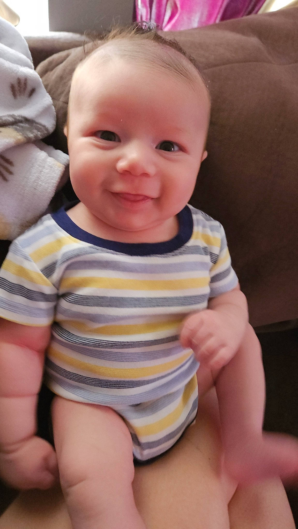 Javion is registered to the contest to win money with this photo: arm, baby, baby_toddler_clothing, cheek, comfort, eye, finger, happy, human_body, iris, lip, mouth, neck, nose, organ, person, skin, sleeve, smile, thumb