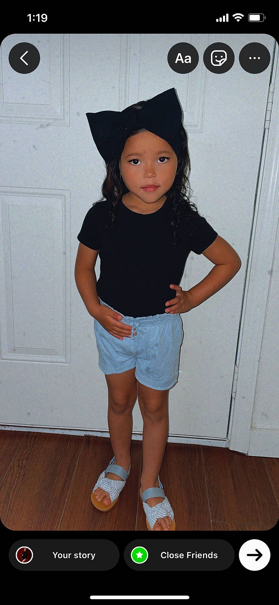 Claudia is registered to the contest to win money with this photo: black_hair, cool, denim, face, hardwood, headwear, human_leg, joint, knee, neck, person, shorts, shoulder, sleeve, standing, street_fashion, t_shirt, thigh, trunk, waist