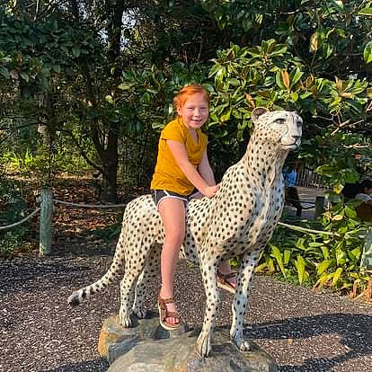 Iliana is registered to the contest to win money with this photo: fawn, felidae, foot, fun, garden, grass, happy, joy, landscape, leisure, pattern, person, plant, recreation, sitting, smile, soil, tail, terrestrial_animal, toddler