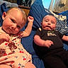 Peyton joined the competition — help win amazing prizes! babies, infants, siblings, portrait, smiling, lying_down, indoor, bed, blankets, blue_bedding, floral_outfit, black_outfit, pacifier, baby_bottle, clothing, faces, eyes, family, home, cute