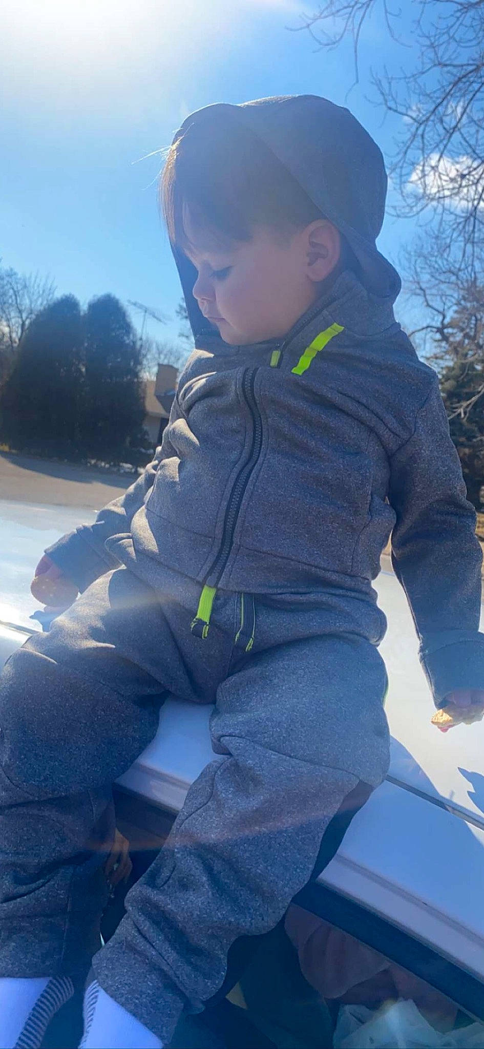 Jaiden joined the competition — help win amazing prizes! cool, denim, electric_blue, freezing, fun, glove, grass, jacket, leisure, person, personal_protective_equipment, play, recreation, sitting, sky, sleeve, toddler, tree, uniform, vertebrate