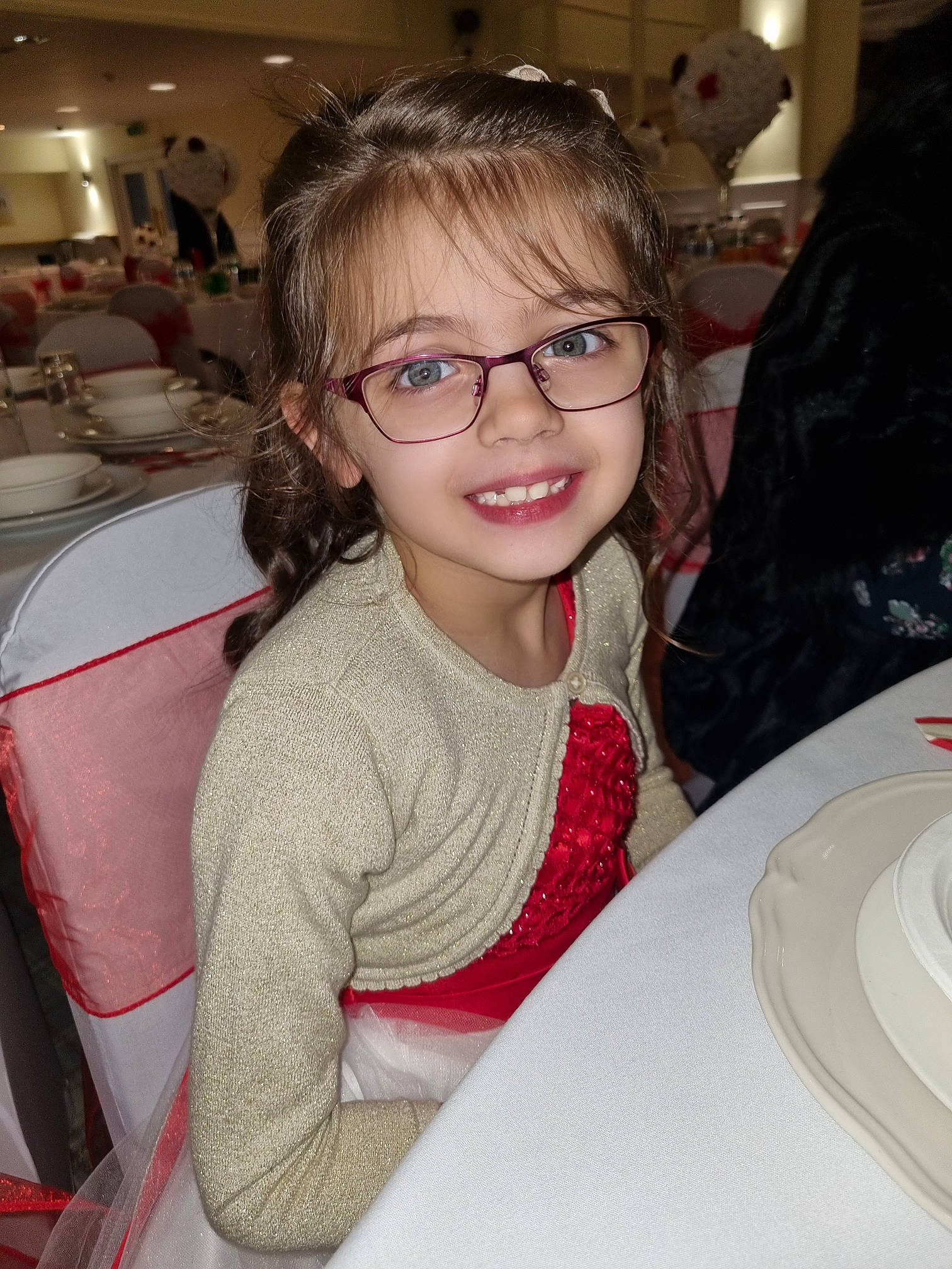 Caitlyn is registered to the contest to win money with this photo: chair, cheek, child, comfort, design, dishware, event, eyewear, fun, glasses, happy, joy, person, plate, sitting, skin, sleeve, smile, t_shirt, table