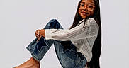 Briannie joined the competition — help win amazing prizes! barefoot, casual, child, face, fashion, girl, glasses, hands, happy, isolated, jeans, long_hair, portrait, posing, reflection, sitting, smiling, star_patch, studio, white_blouse