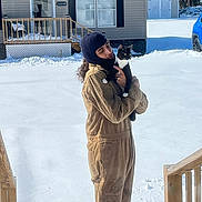 Binx Tyler joined the competition — help win amazing prizes! animal_face, balaclava, blue_car, cat, cozy, deck, holding, house, mobile_home, one_piece_overalls, outdoor, person, pet, porch, portrait, snow, stairs, tuxedo_cat, winter, yard