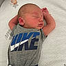Bailey is registered to the contest to win money with this photo: baby, newborn, sleeping, infant, gray_shirt, nike_logo, pacifier, white_bedding, peaceful, cute, child, apparel, resting, indoors, portrait, human, one_person, laying_down, soft_light, skin
