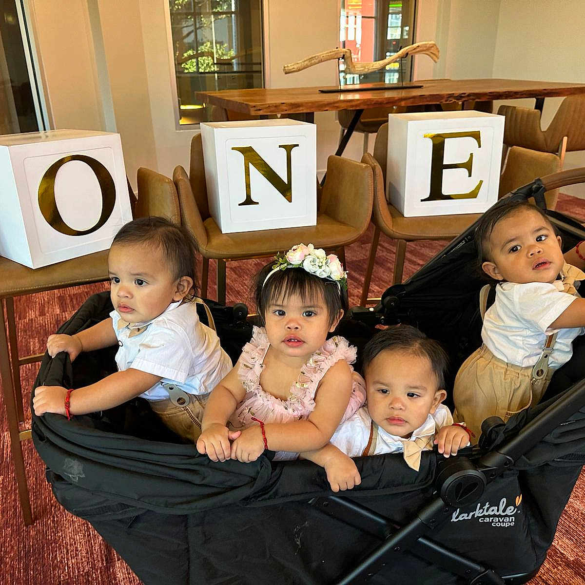 Cuatrillizos joined the competition — help win amazing prizes! baby, blocks, caravan_coupe, carpet, chairs, child, curious, expression, flower_headband, furniture, group, indoor, letters, one, people, red_bracelet, stroller, toddler, white_shirt, wooden_table