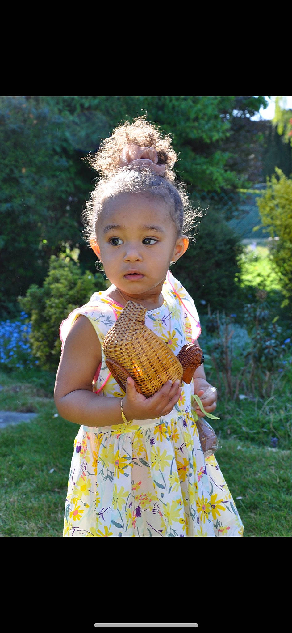 Mia a rejoint le concours — aidez-le/la à gagner de superbes lots ! baby_toddler_clothing, botany, child, day_dress, dress, facial_expression, grass, happy, head, iris, one_piece_garment, pattern, people_in_nature, person, pink, plant, skin, summer, sunlight, toddler