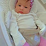 baby, infant, headband, bow, pink_clothing, white_clothing, baby_seat, cushion, cute, portrait, indoor, soft_lighting, face, hands, legs, socks, pattern, comfort, child, newborn