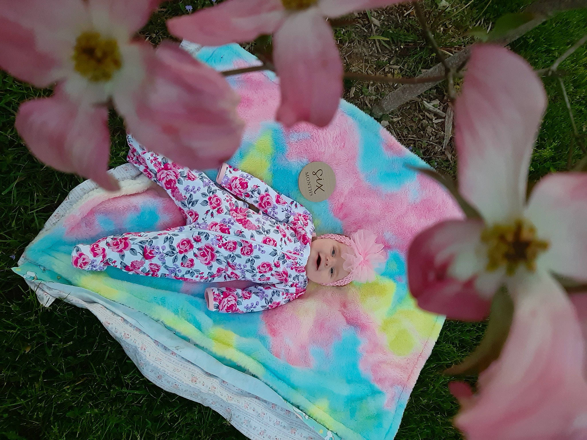 Legacie is registered to the contest to win money with this photo: baby, baby_toddler_clothing, blossom, child, event, fashion_accessory, flower, flowering_plant, grass, groundcover, happy, headwear, leaf, magenta, pattern, person, petal, pink, plant, spring