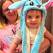 Zakhar is registered to the contest to win money with this photo: baby, child, woman, smile, hat, blue_hat, plush_hat, indoor, person, holding, cute, happy, face, clothing, glasses, pink_shirt, short_sleeve, portrait, expression, joy
