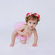 Kimberly is registered to the contest to win money with this photo: baby, child, tutu, flower_crown, pearl_necklace, crawling, pink, cute, smiling, portrait, studio, white_background, innocence, happy, person, young_child, headwear, jewelry, playful, fashion