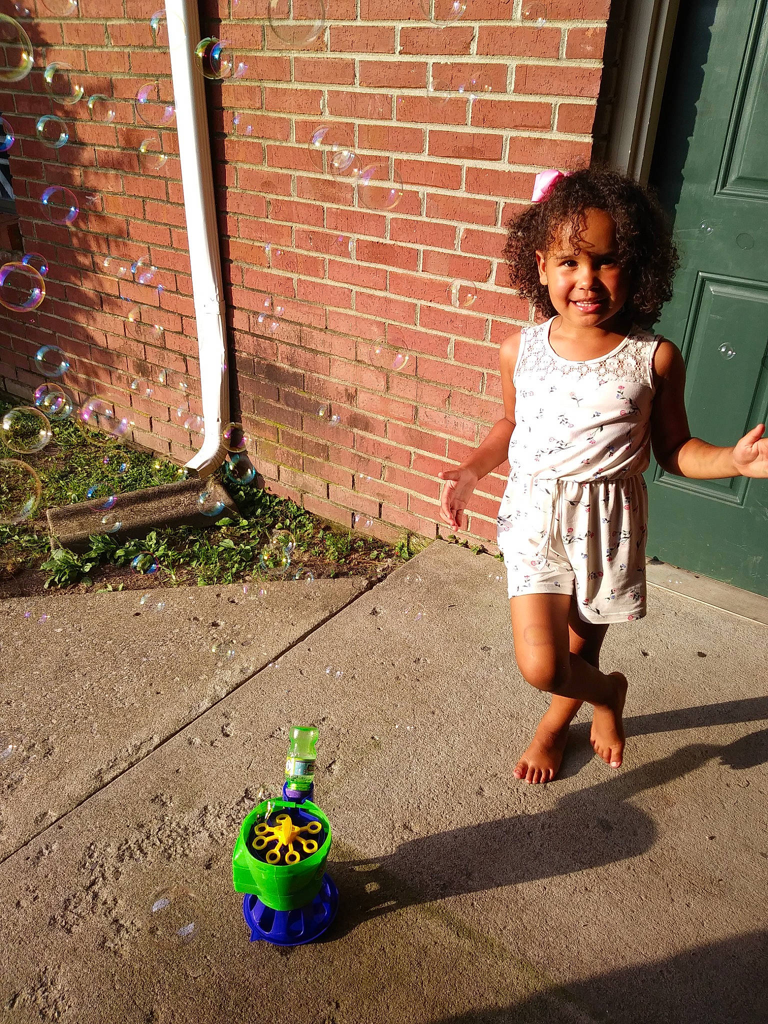 Jaeden is registered to the contest to win money with this photo: adaptation, child, dress, green, joy, people, person, photography, plant, play, shadow, sidewalk, smile, standing, summer, toddler, tree, vacation, yellow