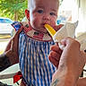 baby, child, person, blue_dress, checkered_pattern, popsicle, hand, tattoo, outdoor, greenery, car, portrait, cute, summer, food, snack, skin, expression, holding, cute_outfit