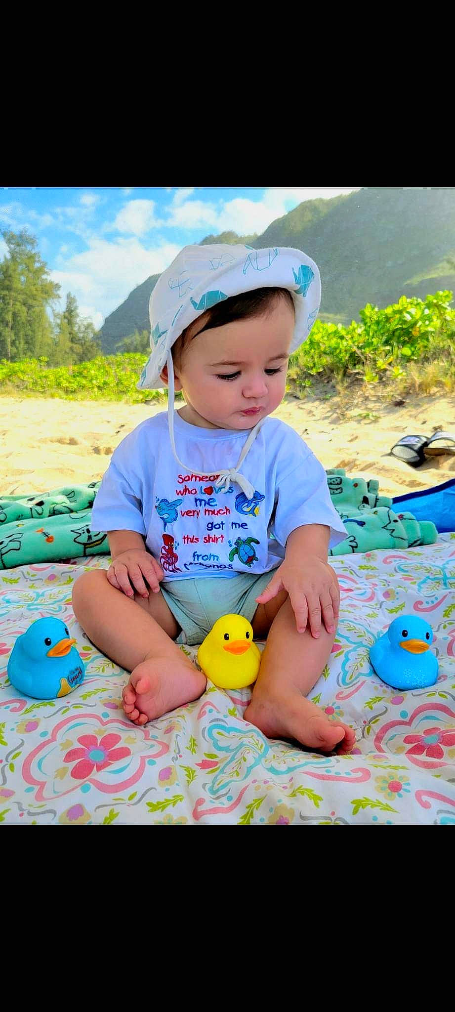 Mason is registered to the contest to win money with this photo: baby, baby_toddler_clothing, blue, cap, child, fun, grass, green, happy, hat, leisure, people_in_nature, person, plant, recreation, skin, sky, t_shirt, toddler, toy