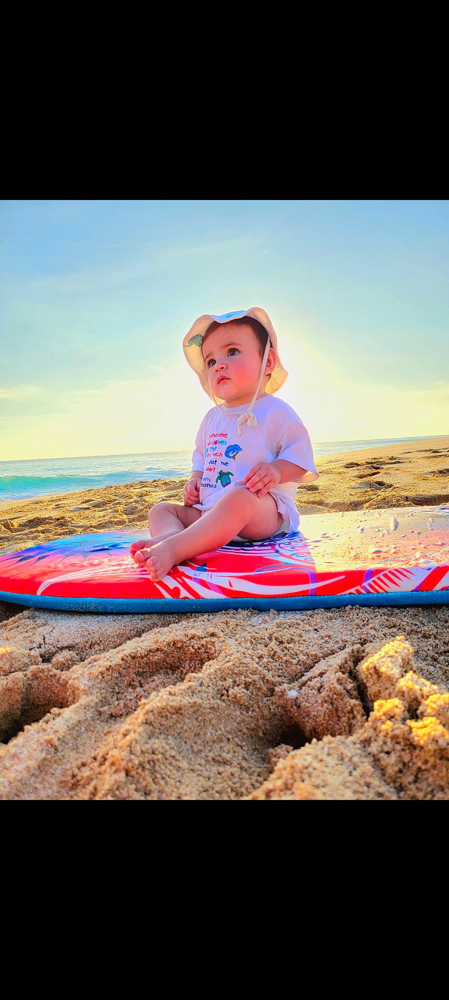 Mason joined the competition — help win amazing prizes! beach, body_of_water, electric_blue, flash_photography, fun, happy, hat, horizon, landscape, leisure, people_in_nature, people_on_beach, person, recreation, sand, shore, sitting, sky, t_shirt, toddler
