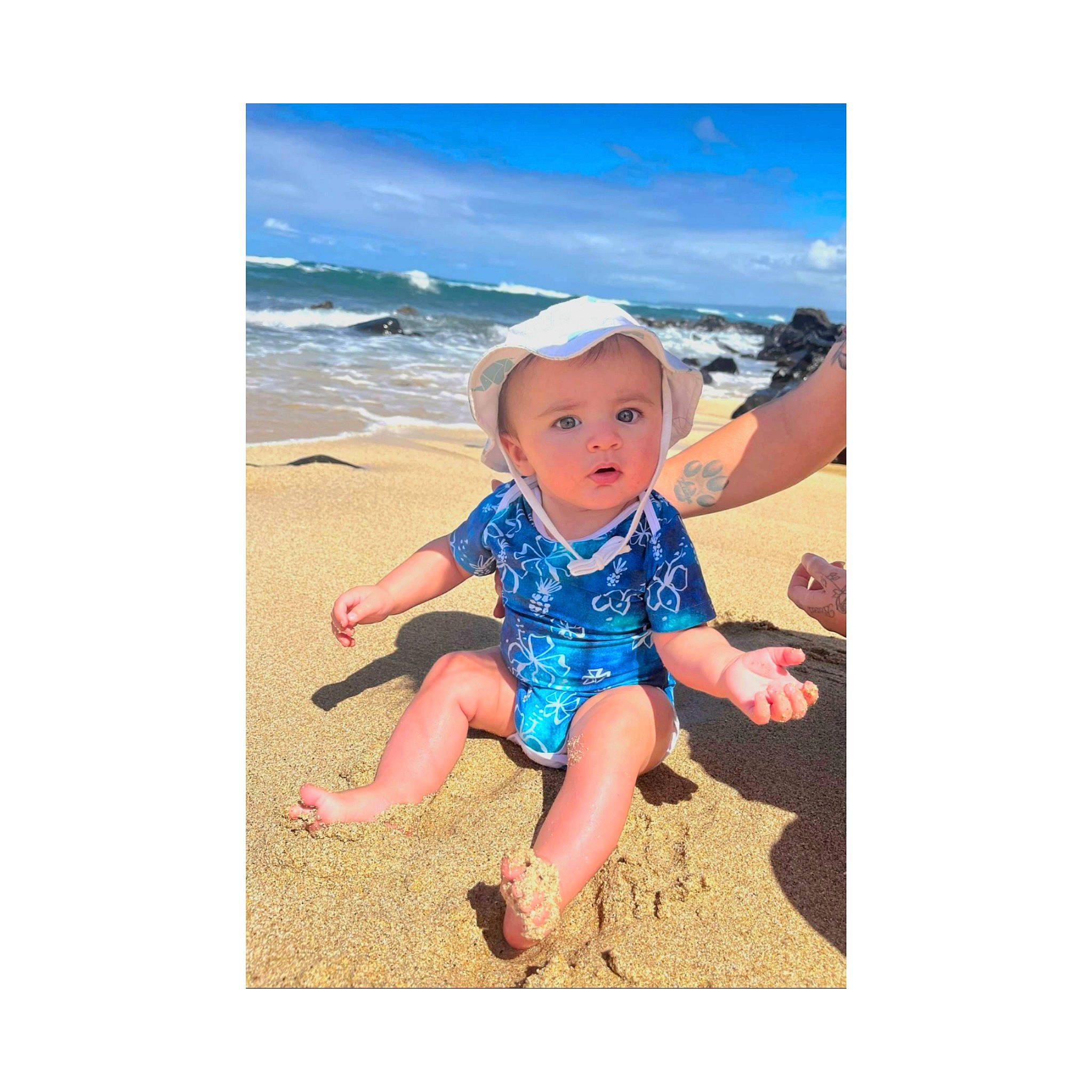Mason is registered to the contest to win money with this photo: baby, baby_toddler_clothing, beach, child, cloud, electric_blue, fun, happy, hat, horizon, landscape, leisure, people_in_nature, person, sitting, sky, sleeve, surprise, t_shirt, toddler