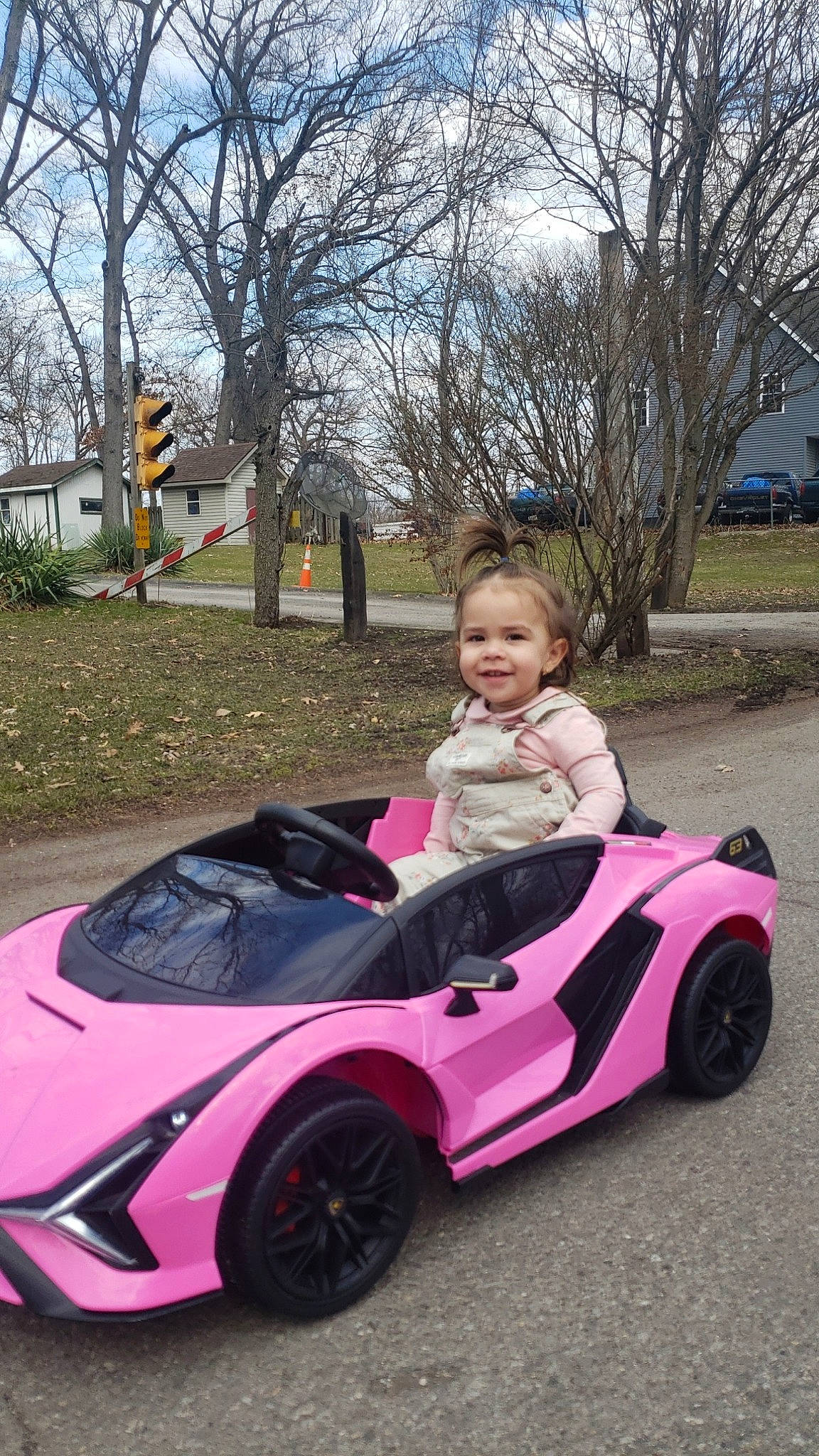 Gianna joined the competition — help win amazing prizes! alloy_wheel, automotive_design, automotive_exterior, automotive_tire, automotive_wheel_system, car, grass, hood, joy, mode_of_transport, motor_vehicle, person, pink, plant, riding_toy, sky, smile, tire, tree, vehicle