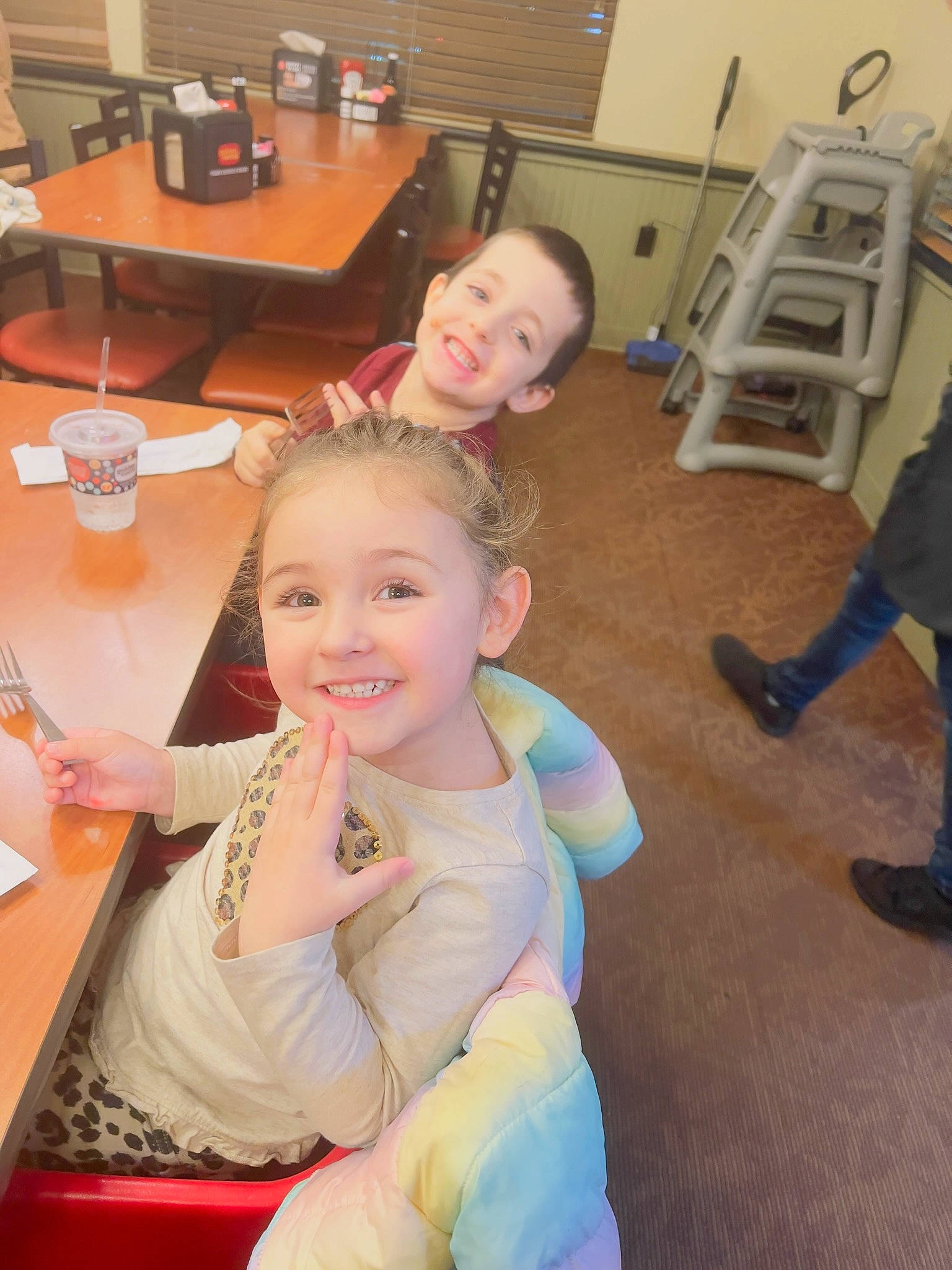 Hyleigh is registered to the contest to win money with this photo: chair, child, desk, event, flooring, fun, happy, joy, leisure, person, plate, room, sitting, skin, smile, t_shirt, table, tableware, toddler, vacation