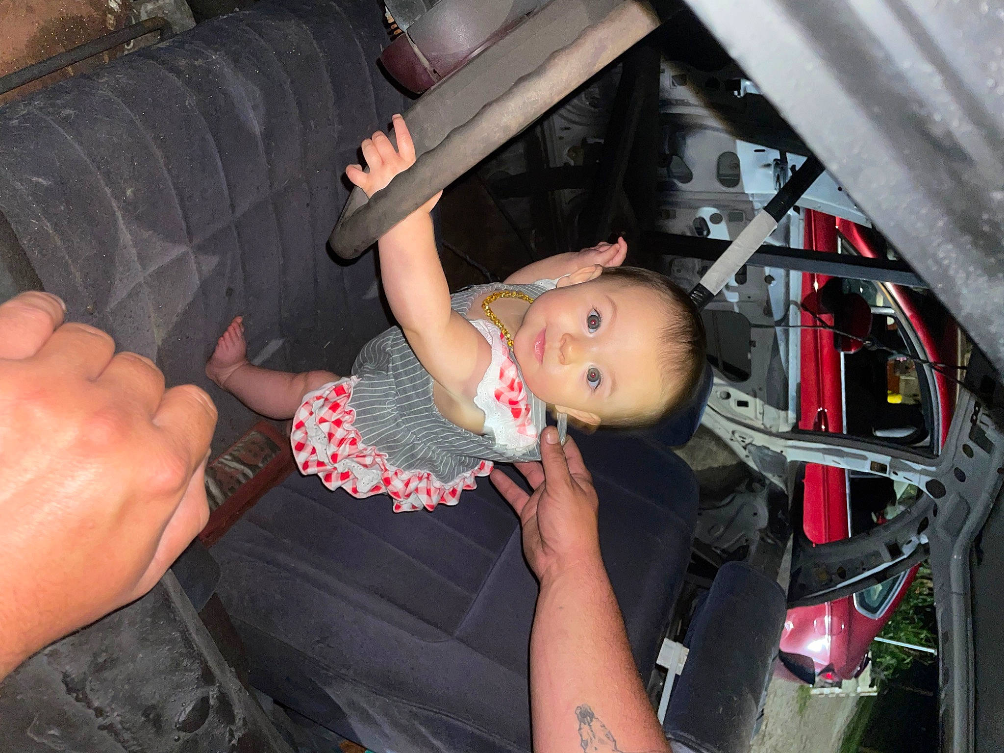 Laura is registered to the contest to win money with this photo: auto_part, automotive_design, automotive_exterior, automotive_lighting, automotive_tire, baby, baby_toddler_clothing, finger, flash_photography, fun, hand, human_leg, motor_vehicle, person, rim, thigh, tire, toddler, vehicle, vehicle_door