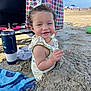 toddler, child, beach, sand, smile, curly_hair, bow, towel, sunny, outdoor, summer, vacation, happy, play, clothing, blue_sky, beach_umbrella, water_bottle, footwear, polka_dot_bag