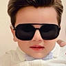 bow_tie, boy, casual, child, childhood, closeup, cool, cute, eyewear, face, fashion, hairstyle, indoor, person, portrait, smile, style, sunglasses, white_shirt, young