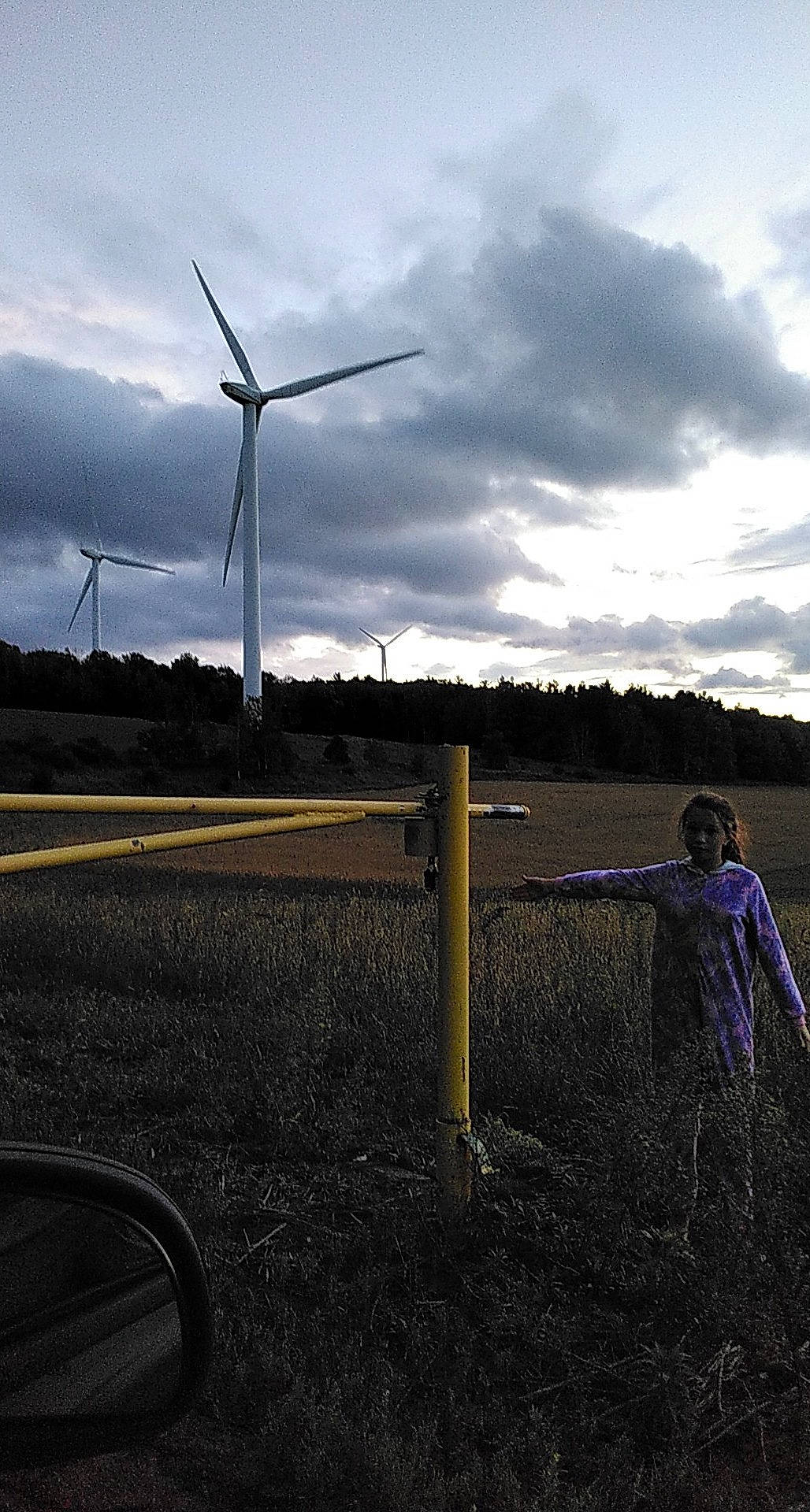Lakesha is registered to the contest to win money with this photo: atmosphere, cloud, ecoregion, electricity, flash_photography, grassland, highland, land_lot, landscape, natural_environment, person, plain, plant, rural_area, sky, tints_and_shades, tree, turbine, under_exposed, wind_farm