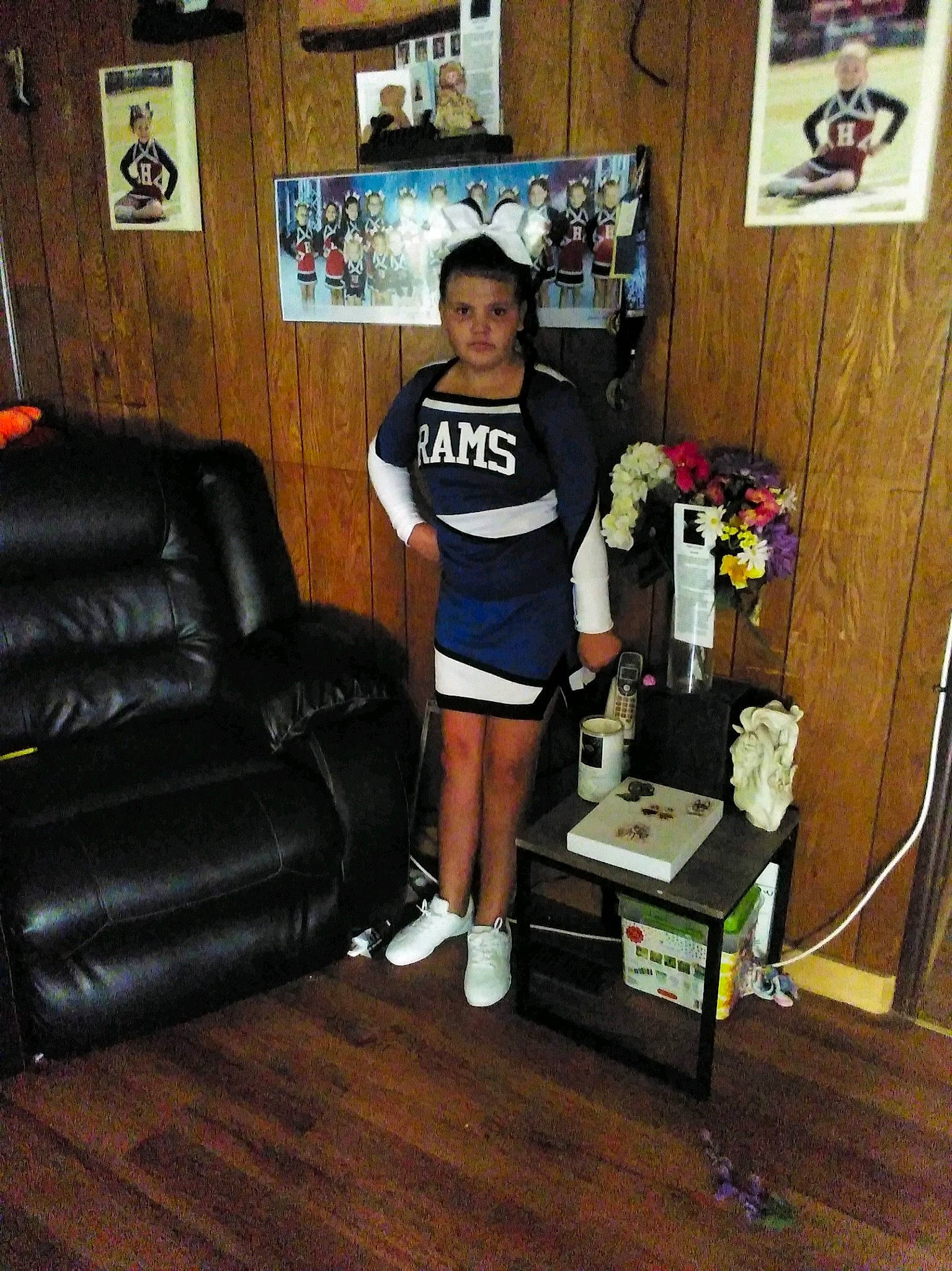 Stephanie is registered to the contest to win money with this photo: chair, comfort, couch, flooring, hardwood, hat, human_leg, living_room, luxury_vehicle, machine, person, picture_frame, room, shorts, smile, sofa_bed, sportswear, studio_couch, t_shirt, thigh