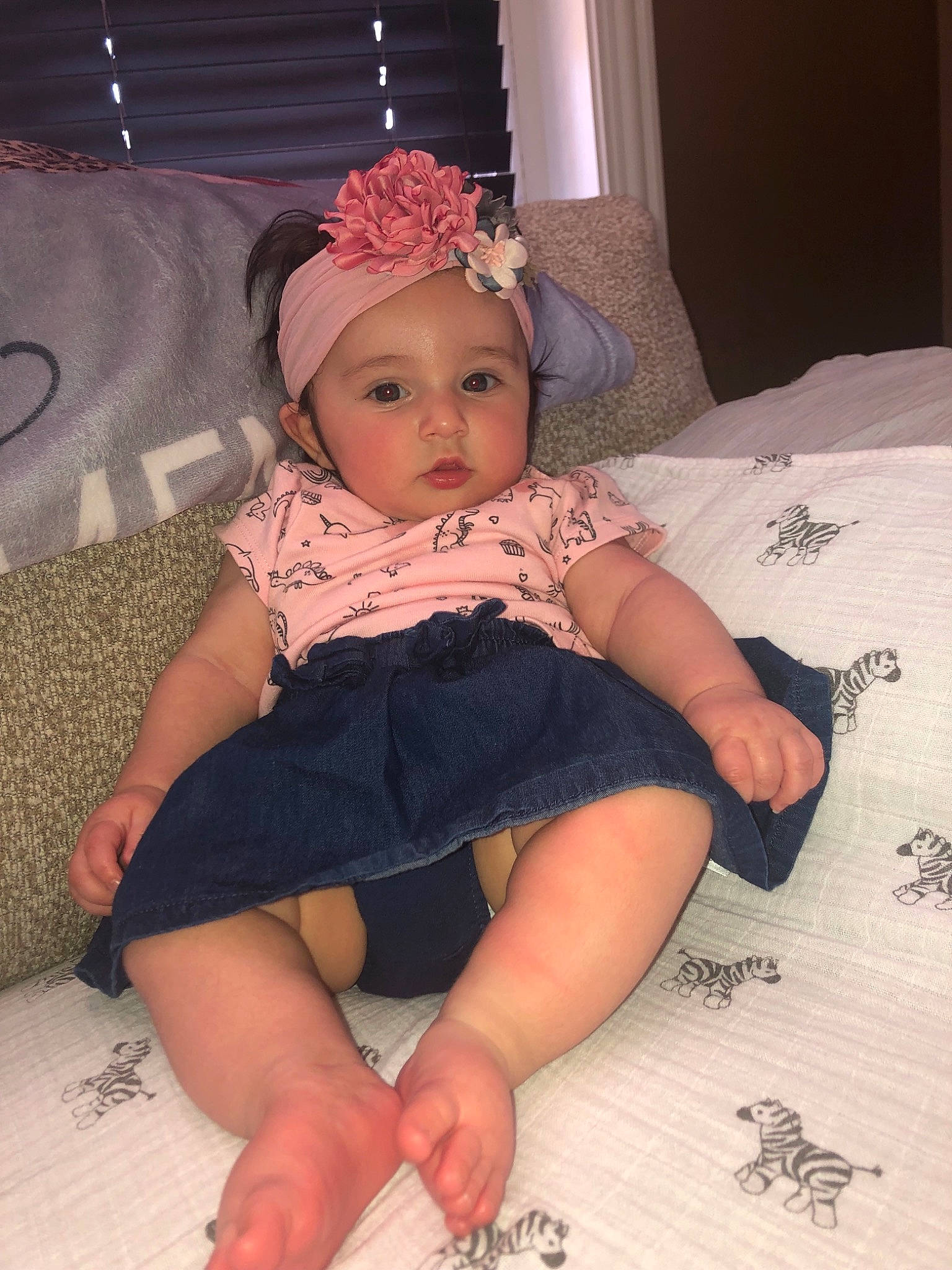 Audree is registered to the contest to win money with this photo: arm, baby, baby_toddler_clothing, barefoot, cheek, child, finger, foot, hair_accessory, hand, headgear, headpiece, human_leg, joint, leg, person, pink, sitting, skin, thigh