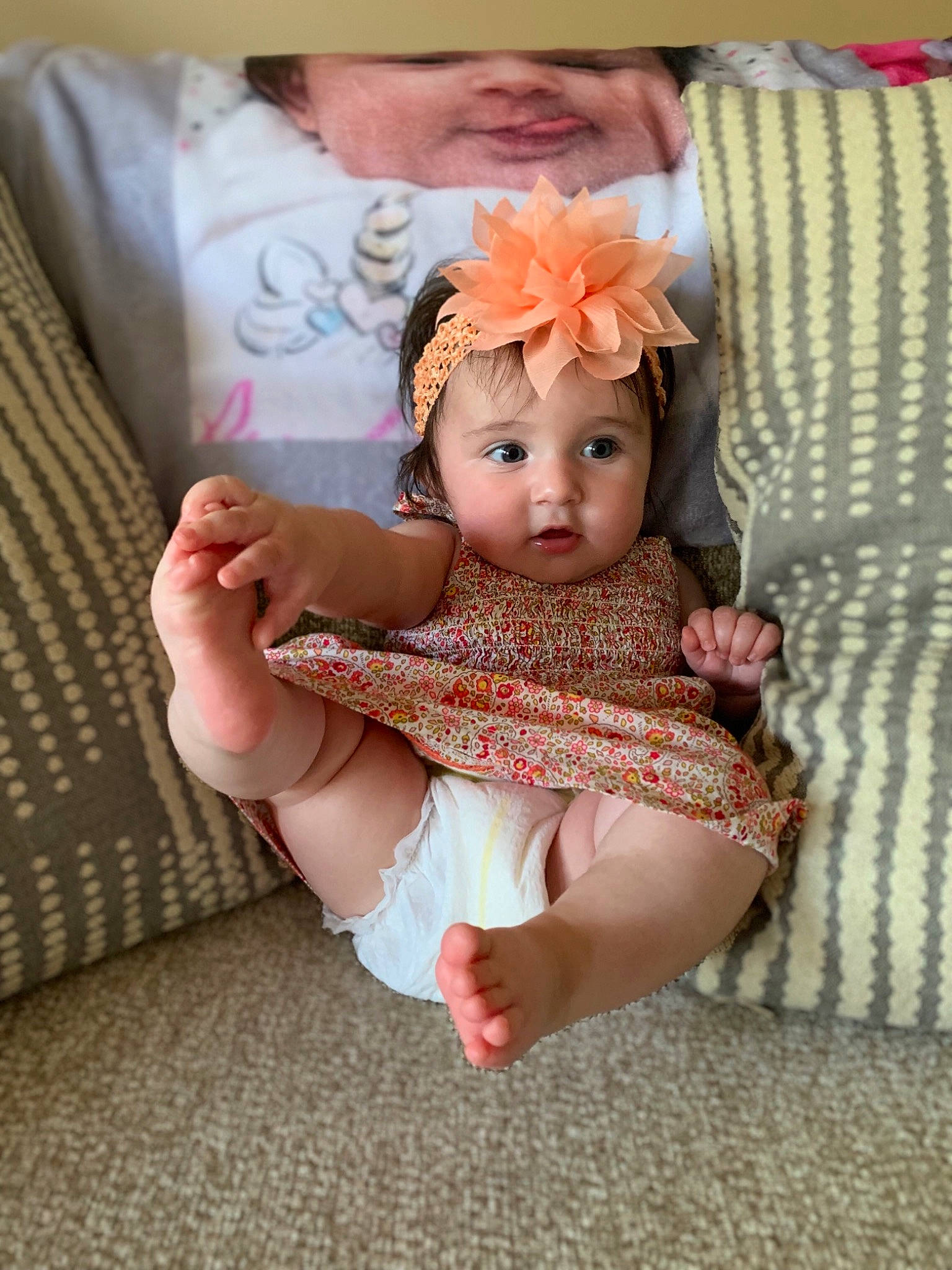 Audree is registered to the contest to win money with this photo: baby, baby_products, baby_toddler_clothing, cheek, child, eye, hair_accessory, head, headgear, iris, pattern, person, pink, product, sitting, skin, textile, toddler, toy, yellow