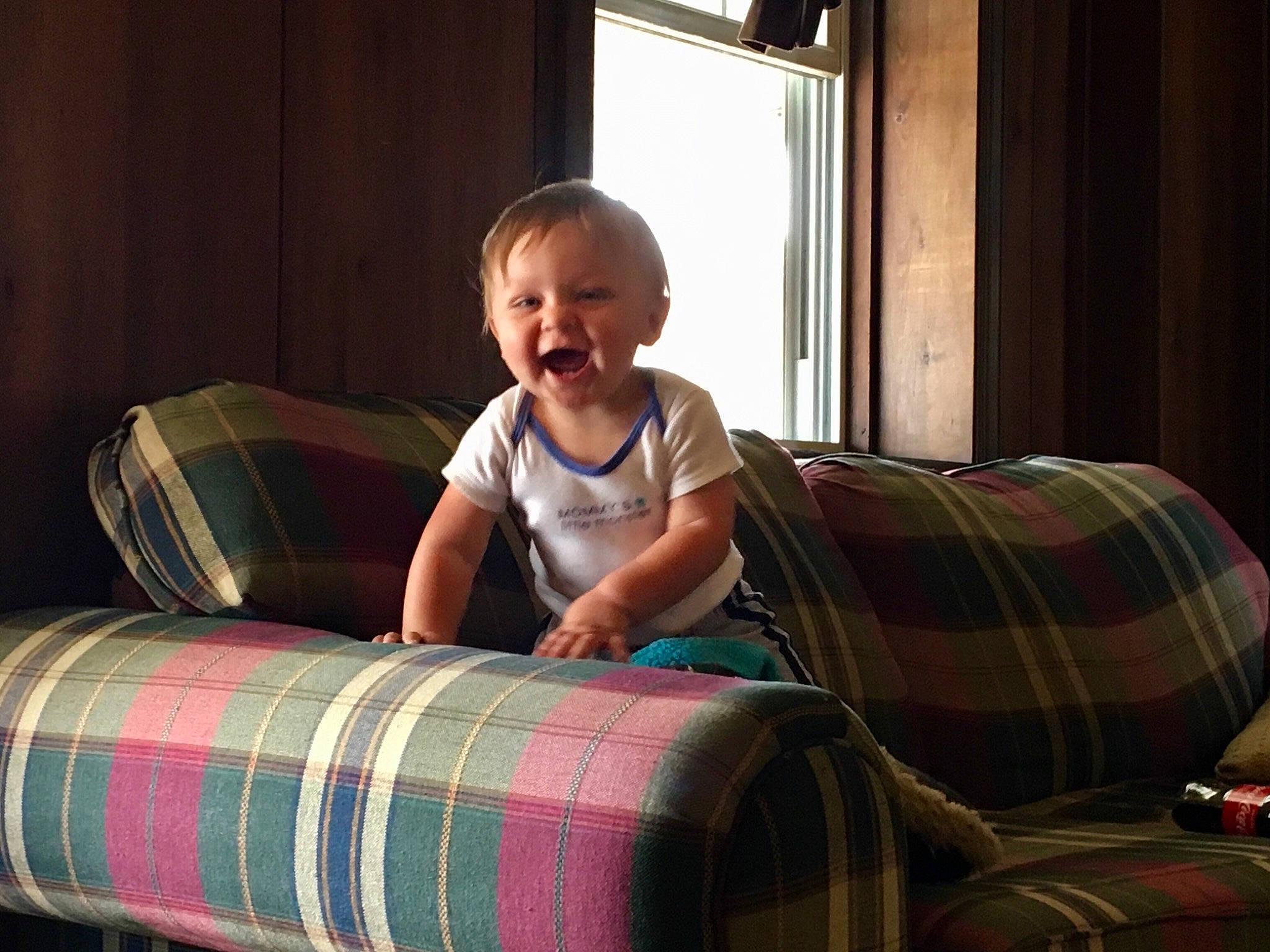 Wyatt is registered to the contest to win money with this photo: child, comfort, couch, design, furniture, pattern, person, plaid, room, sitting, tartan, textile, toddler, vacation