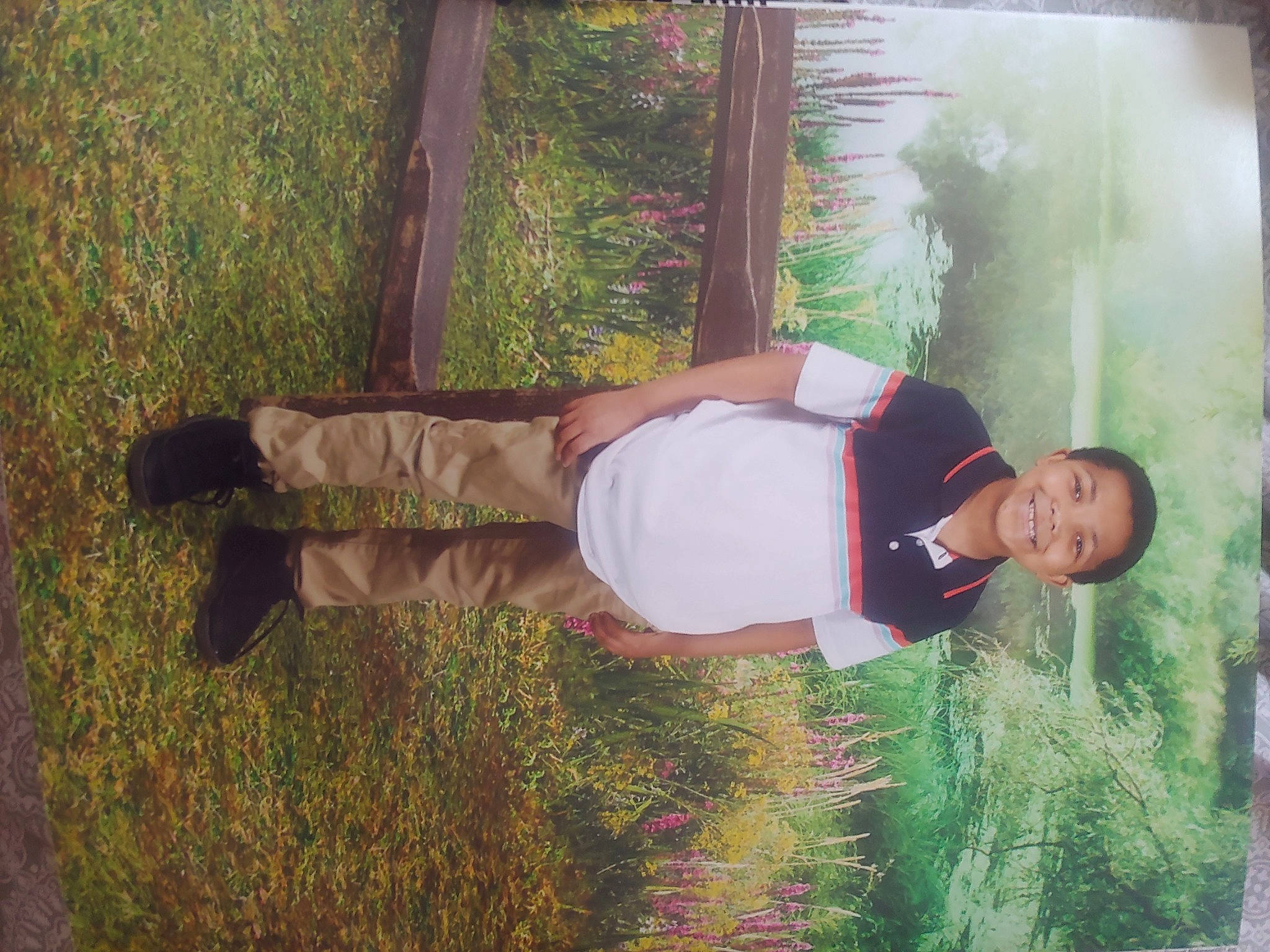 Bobby is registered to the contest to win money with this photo: elbow, fun, grass, grassland, happy, human_leg, joy, knee, leisure, people_in_nature, person, plant, shrub, sleeve, soil, t_shirt, thigh, tints_and_shades, wood, wrist