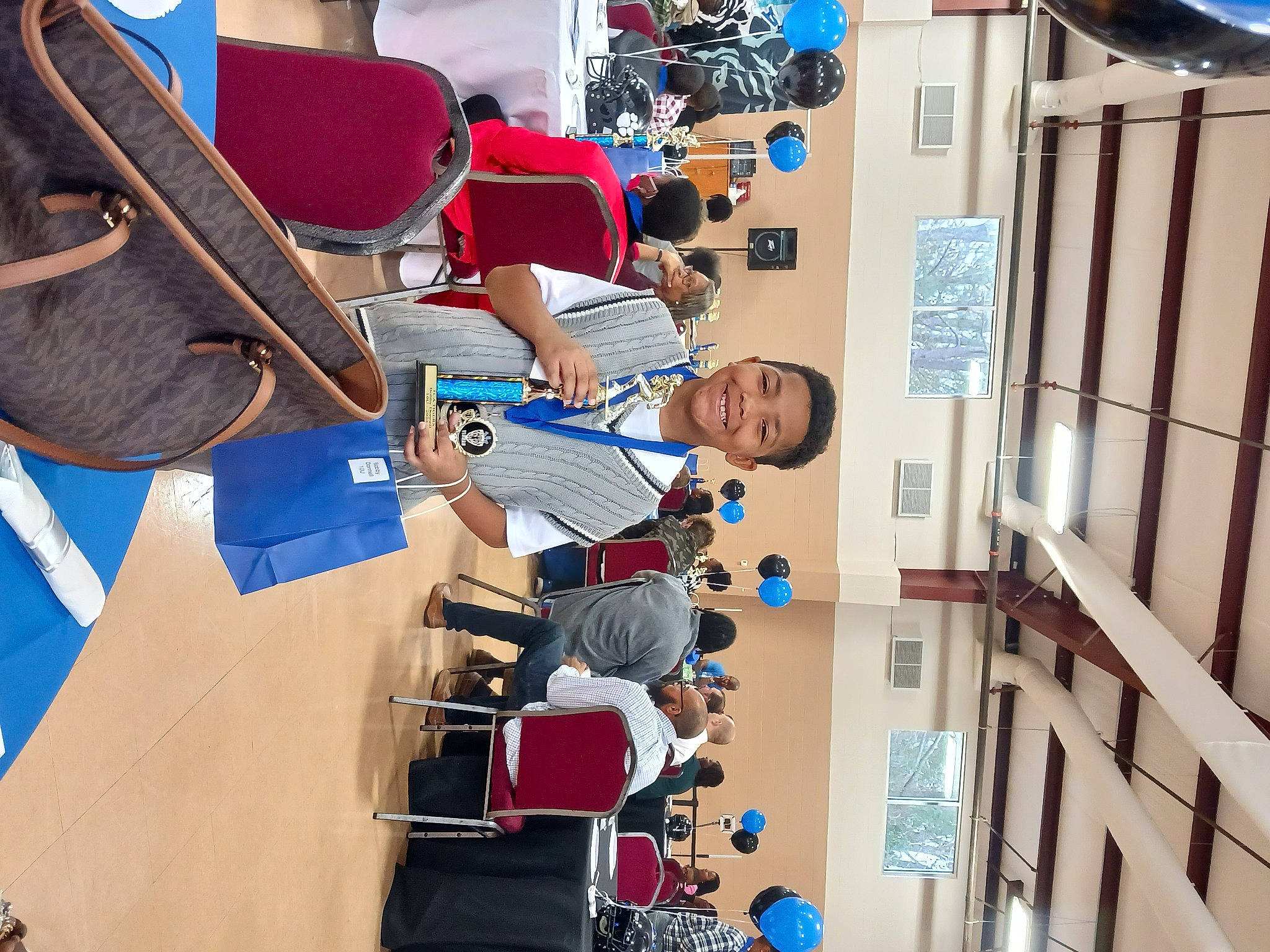 Bobby joined the competition — help win amazing prizes! blue, chair, customer, engineering, event, eyewear, folk_instrument, guitar, job, joy, leisure, machine, musical_instrument, person, plucked_string_instruments, recreation, room, string_instrument, t_shirt, wood