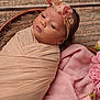 newborn, baby, swaddled, headband, flower, pink, blanket, basket, portrait, cute, infant, soft, cozy, sleepy, wrapped, child, wooden_floor, fabric, delicate, peaceful