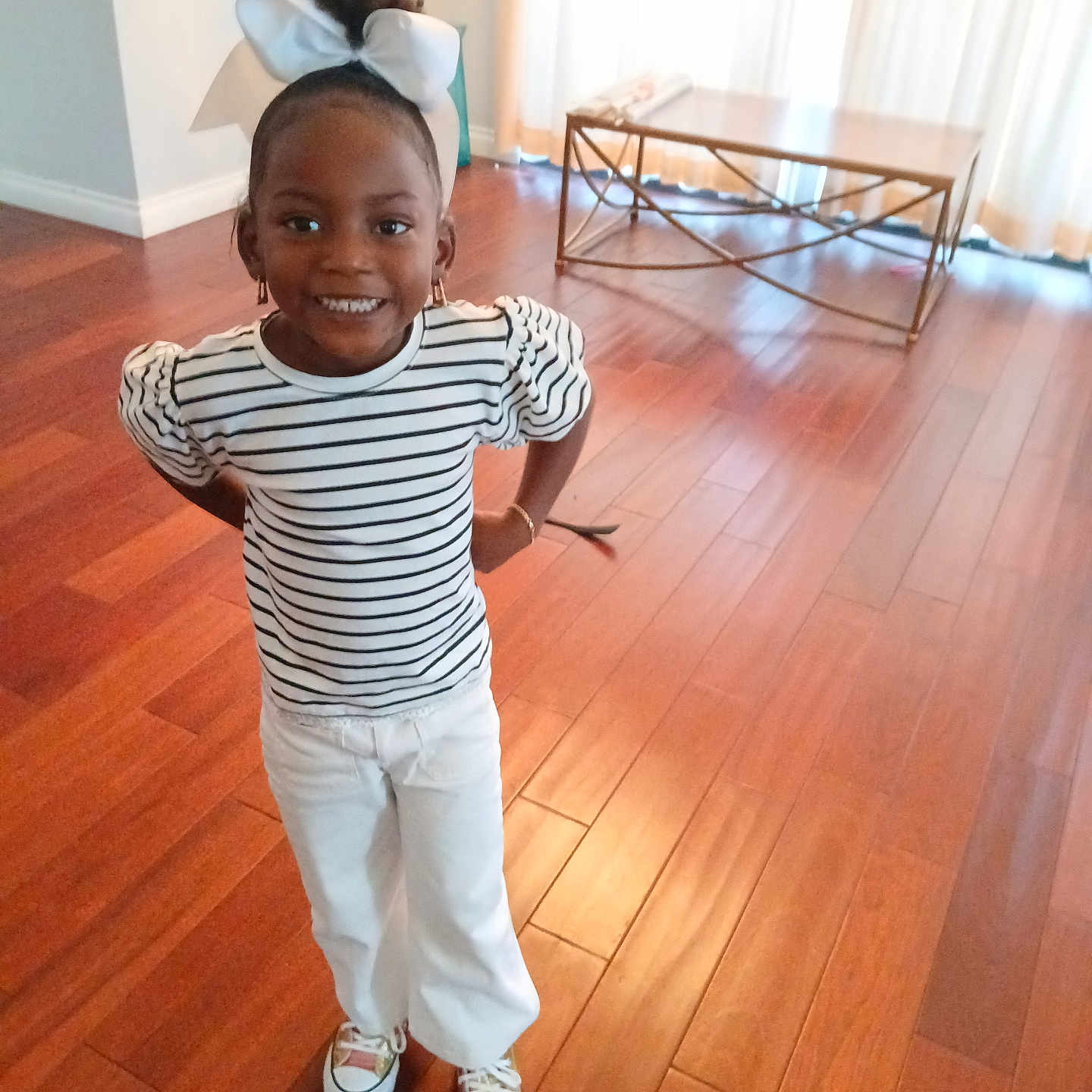 Mai'Lynne is registered to the contest to win money with this photo: accessories, boy, bracelet, child, clothing, face, footwear, hardwood, head, indoors, interiordesign, male, pants, person, photography, portrait, shoe, sneaker, t_shirt, wood