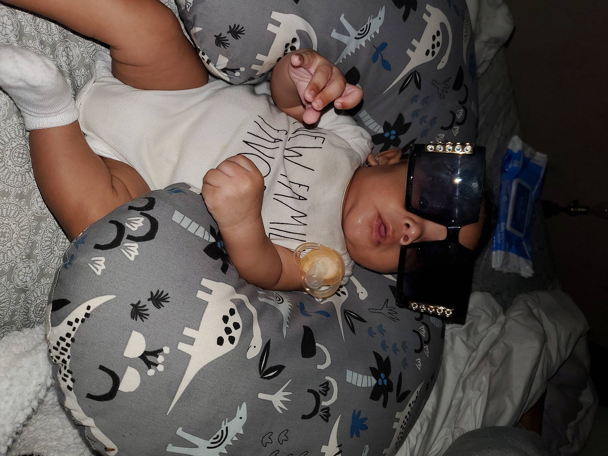 Canaan is registered to the contest to win money with this photo: abdomen, baby, baseball_cap, camouflage, cap, chest, comfort, elbow, event, eyewear, fun, gesture, hat, human_leg, knee, military_camouflage, pattern, person, t_shirt, thigh