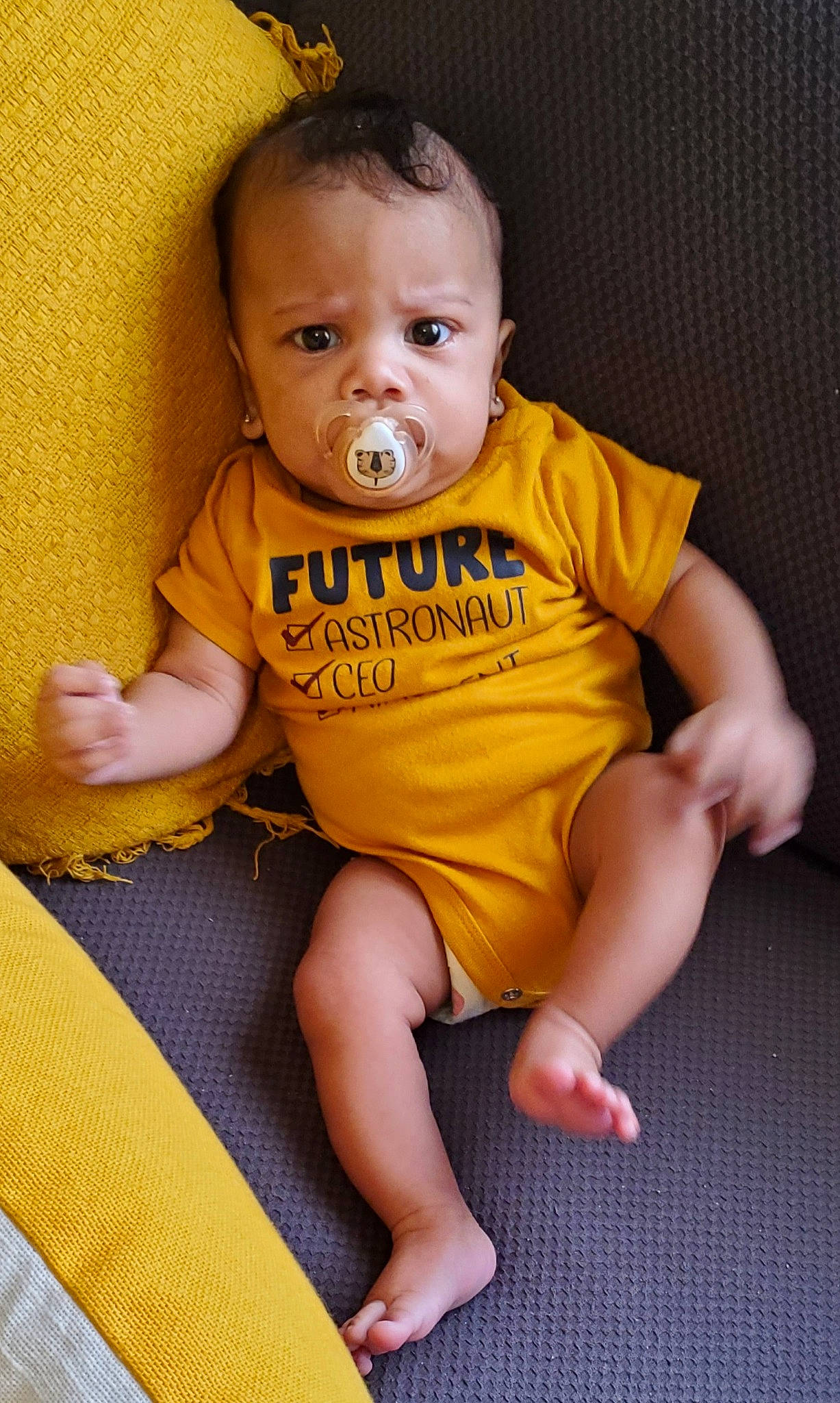 Canaan is registered to the contest to win money with this photo: baby, baby_toddler_clothing, cheek, child, chin, eye, face, finger, hair, head, human_body, iris, lip, mouth, neck, nose, person, skin, sleeve, t_shirt