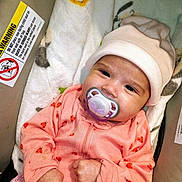 Bella Mia joined the competition — help win amazing prizes! baby, blanket, car_seat, child, closeup, cozy, cute, fist, hat, indoors, infant, infant_clothing, ladybug_pattern, newborn, pacifier, person, pink_clothing, sleepy, soft_texture, warning_label