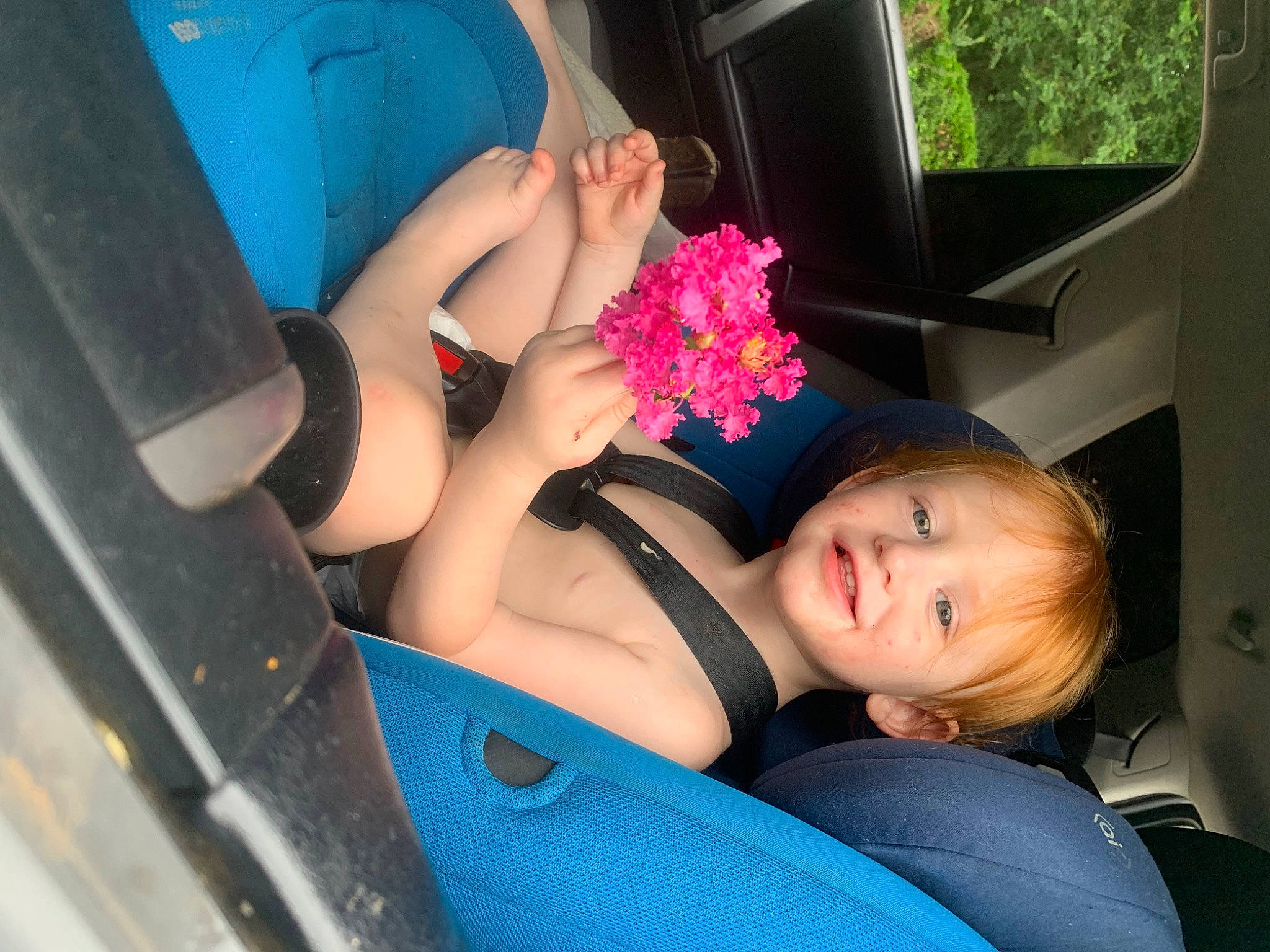 Ashton is registered to the contest to win money with this photo: automotive_design, automotive_exterior, black_hair, car, car_seat, comfort, dress, finger, human_body, joy, knee, lap, leg, motor_vehicle, person, shorts, shoulder, thigh, trunk, vehicle