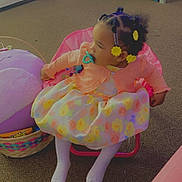 Aziyah is registered to the contest to win money with this photo: balloon, child, clothing, dress, face, female, food, furniture, girl, head, hosiery, person, photography, portrait, purple, sitting, sock, sphere, sweets, tape