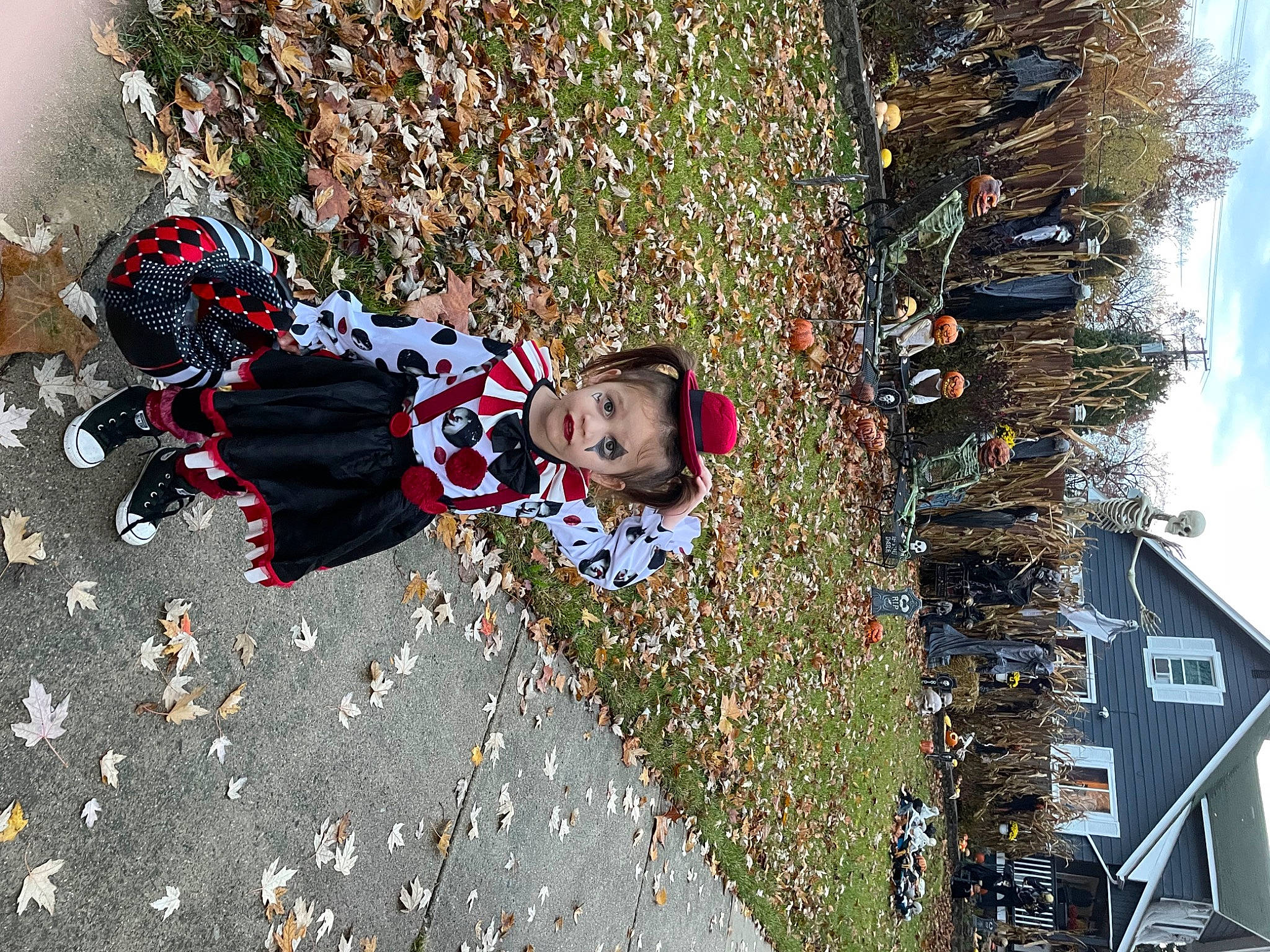 Makennah is registered to the contest to win money with this photo: asphalt, carmine, flooring, fun, house, human_settlement, leaf, leisure, pattern, people_in_nature, person, plant, road_surface, sidewalk, sky, toddler, travel, tree, window, winter