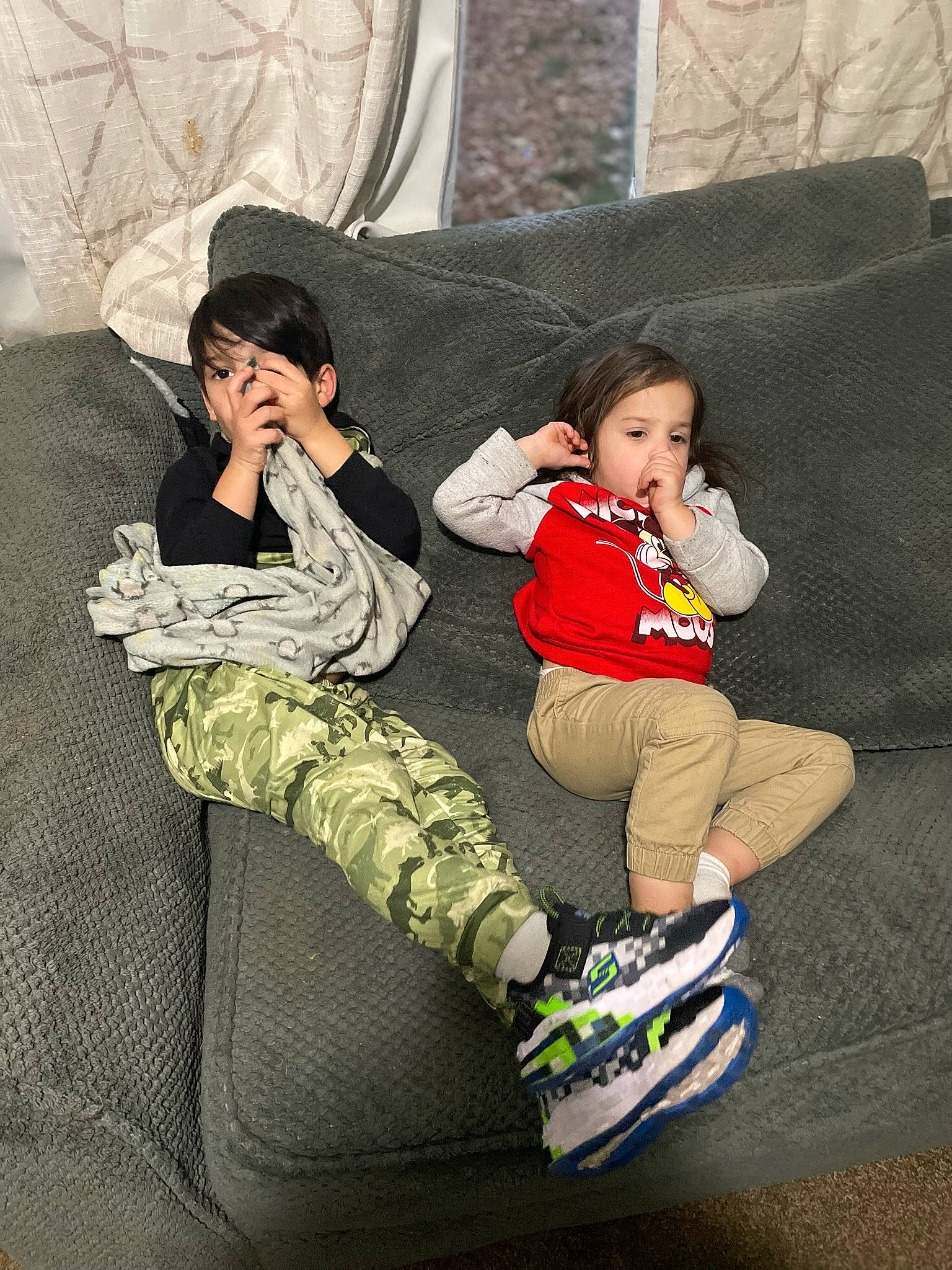 Makennah is registered to the contest to win money with this photo: baby, child, comfort, couch, footwear, fun, grass, human_leg, knee, leg, leisure, outdoor_shoe, person, recreation, room, shoe, sitting, sneakers, thigh, toddler