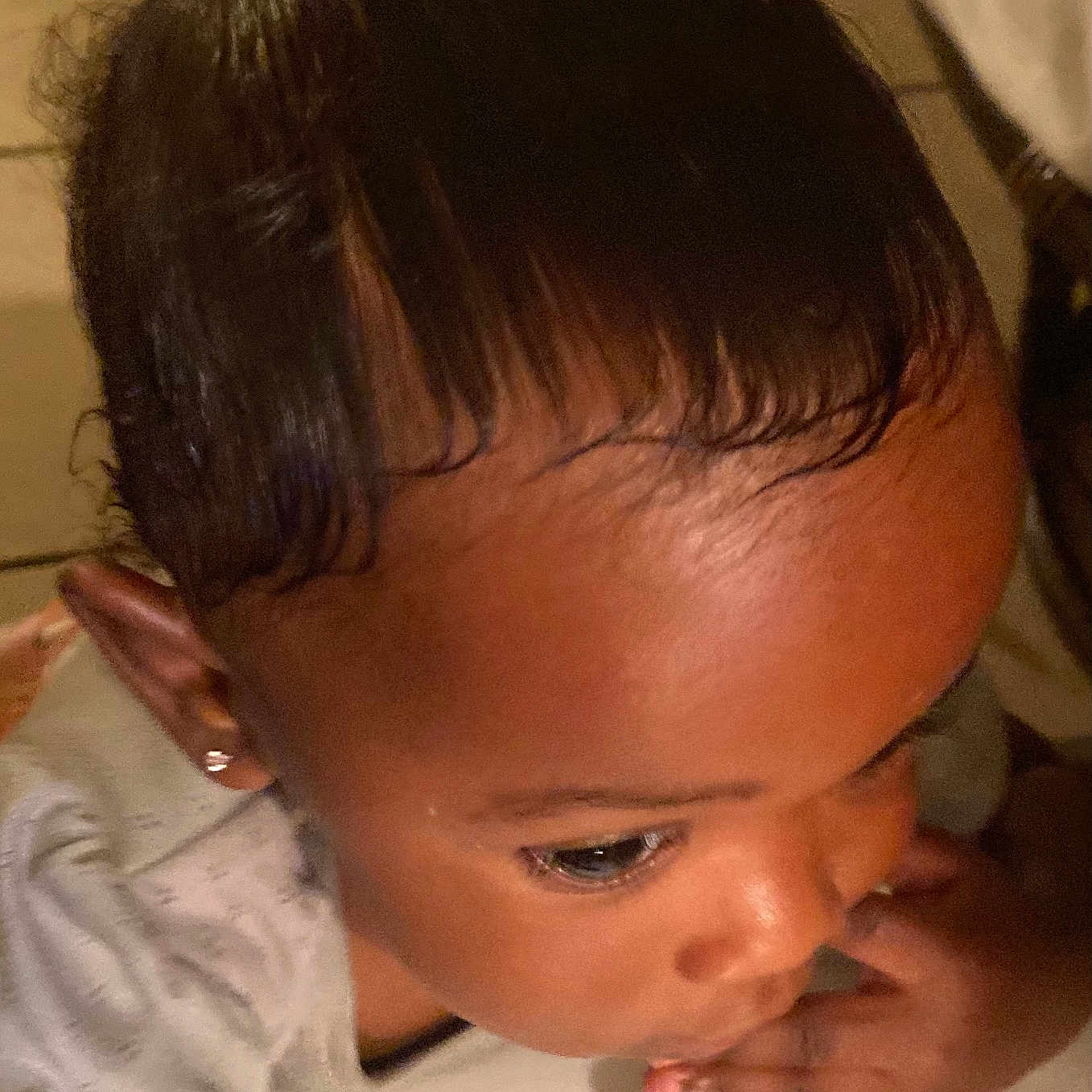Majestie is registered to the contest to win money with this photo: baby, child, closeup, clothing, curious, earring, face, fingers, floor, hair, hand, indoor, looking_down, person, portrait, short_sleeves, skin, tile, toddler, young_child