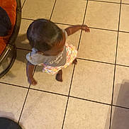 Majestie is registered to the contest to win money with this photo: toddler, child, floor, tile, clothing, shirt, shorts, barefoot, indoor, motion, person, head, arm, foot, furniture, chair, home, skin, hair, shadow