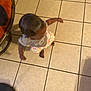 toddler, child, floor, tile, clothing, shirt, shorts, barefoot, indoor, motion, person, head, arm, foot, furniture, chair, home, skin, hair, shadow