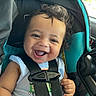 baby, child, car_seat, smiling, curly_hair, happy, infant, seatbelt, car_interior, blue, black_straps, person, cute, safety, toddler, joyful, portrait, car, seat, young