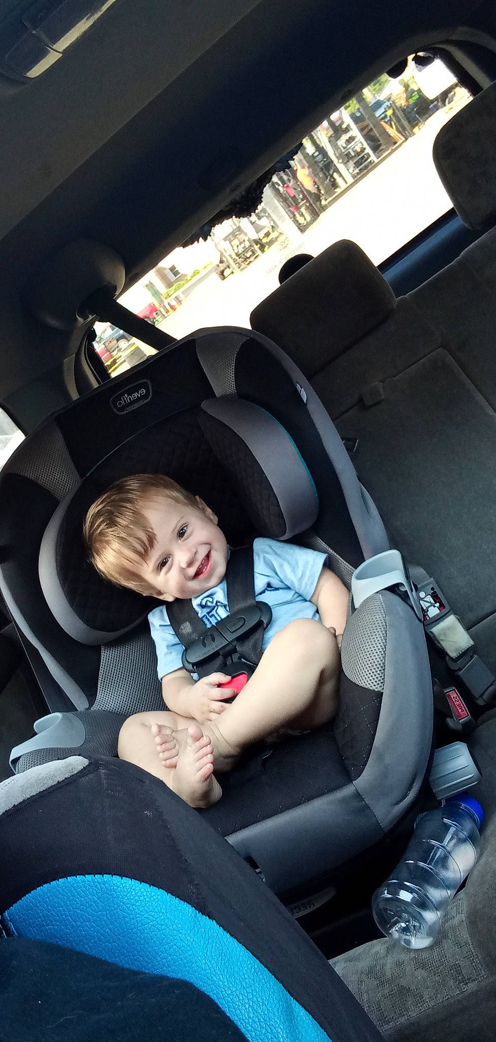 Connor is registered to the contest to win money with this photo: auto_part, automotive_design, automotive_exterior, automotive_wheel_system, baby_in_car_seat, car, car_seat, car_seat_cover, comfort, family_car, head_restraint, joy, motor_vehicle, person, personal_luxury_car, seat_belt, smile, steering_part, steering_wheel, toddler