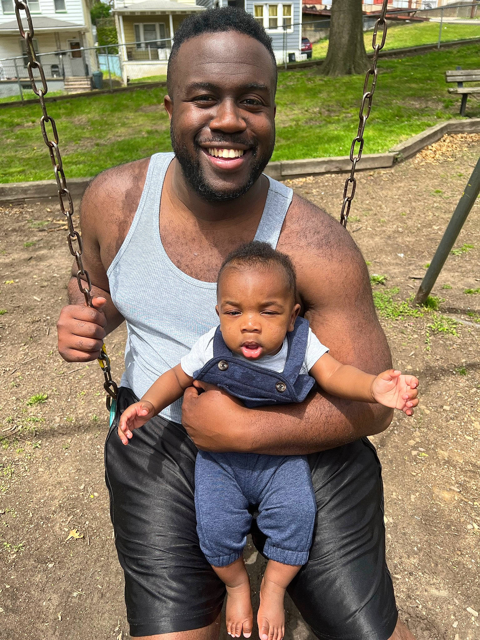 Koji is registered to the contest to win money with this photo: baby, black, chest, child, fun, grass, hand, happy, joy, leg, leisure, person, photograph, product, recreation, shorts, skin, smile, snapshot, swing